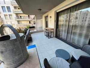 a balcony of a building with a large window at Appartement Relaxant in Nice