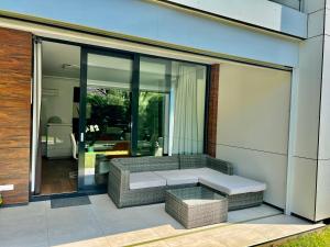 a living room with a couch and a table at Azúr Port Siófok Balaton in Siófok