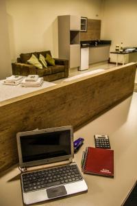 a laptop computer sitting on a table in a room at Blu Apart Hotel in Mogi Guaçu