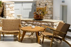 a table and two chairs and a table and a table at Anemomylos Residence in Naousa