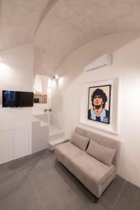 a living room with a couch and a painting on the wall at Casa Mirelli By Dimorra in Naples