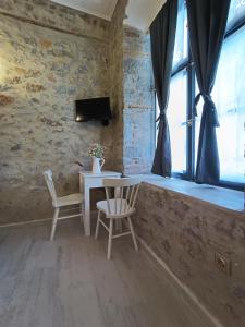 a dining room with a table and chairs and a window at Villa Sunrise in Hydra