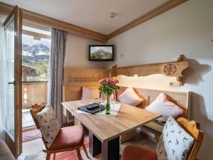 a dining room with a wooden table and chairs at Schnapperhof in Going am Wilden Kaiser