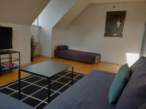 a living room with a couch and a table at Dronninglund Appartements in Dronninglund