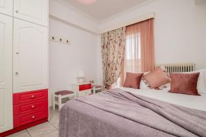 a bedroom with a large bed and a red dresser at La Casa Di Nina in Laganas +35 photos