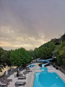 um resort com uma piscina e um escorrega aquático em Camping la Source em Thérondels
