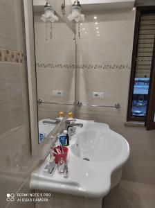 a bathroom with a white sink and a mirror at Da FELICIA & Fabrizio in Rome +40 photos
