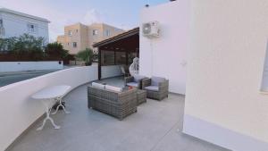 a balcony with chairs and a table on a building at STAY Kapparis Symphony in Paralimni