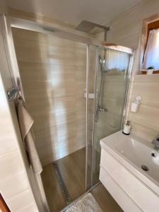a bathroom with a shower and a sink at Panoráma Csopak in Csopak +46 photos