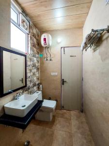 a bathroom with a sink and a shower at Blossom Bliss Resort in Bhīm Tāl