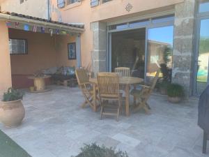 a patio with a table and chairs on a patio at YOGAILO maison de charme in Colombiers +6 photos