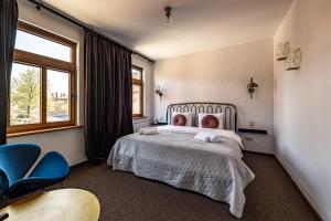 a bedroom with a bed with two babies laying on it at MORE Hotel in Liepāja