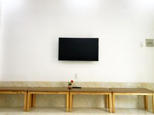 a flat screen tv hanging on a white wall at Prana Vũng Tàu in Vung Tau