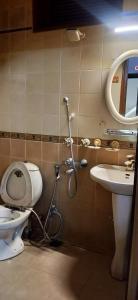 a bathroom with a toilet and a sink at Trehan's Residence in New Delhi