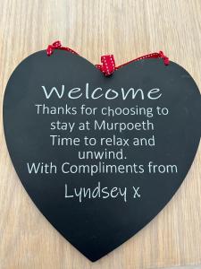 a sign that says welcome thanks for choosing to stay at migrant time to relax at Idyllic holiday near Abersoch in Mynytho