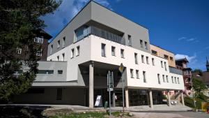 a white building with a lot of windows at Pension Janský Potok II. in Janske Lazne +52 photos