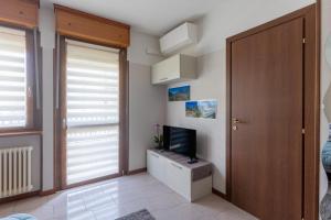 a living room with a television and a door at Casa vacanze- Debra in Aosta