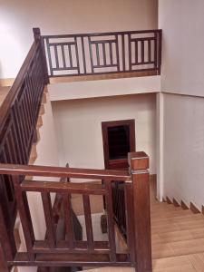 a staircase in a building with a wooden railing at Phamarn View Guesthouse in Ban Nahin-Nai
