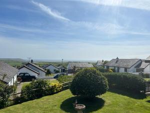 a house with a bird sitting on the grass at Idyllic holiday near Abersoch in Mynytho