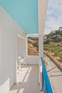 a balcony with white walls and a view of the ocean at Venetia Studios in Karpathos