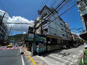a city street with a building on the side of the road at Heaven House in Patong Beach