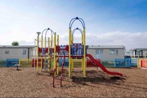 a playground with a slide in a playground at Whitstable, CW18, 2 bed park home, Alberta Holiday Park in Seasalter