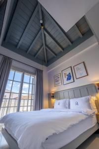 a bedroom with a large bed and a large window at Blue Alle Alaçatı in Alaçatı +128 photos
