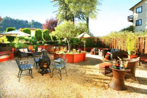 a backyard with a fire pit and chairs and tables at West Sonoma Inn & Spa in Guerneville