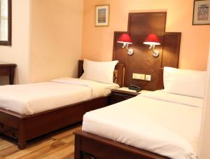 Postel nebo postele na pokoji v ubytování HOTEL METRO REGENCY