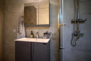 a bathroom with a sink and a shower at Chic Apartment in Nature in Kalamata +32 photos