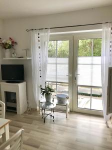 a living room with a sliding glass door at Friesenhof in Friedrichskoog