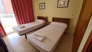 En eller flere senge i et værelse på Apartamento Torre Europa