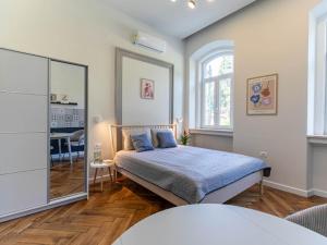 a bedroom with a bed and a mirror in it at Polai Park Apartments in Pula