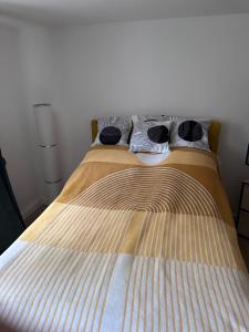 ein Bett mit gestreifter Bettdecke und 2 Kissen in der Unterkunft Appartement im Geteviertel in Bremen