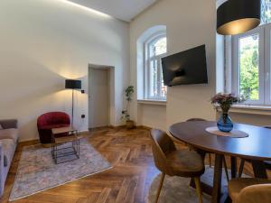 a living room with a table and a couch at Polai Park Apartments in Pula