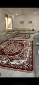 a living room with a large rug on the floor at Sun shine chalet in Al Ḩadd