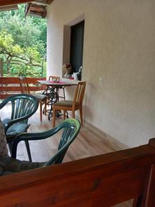 a patio with chairs and a table and tables and chairs at Studio Sanja Knez in Soko Banja