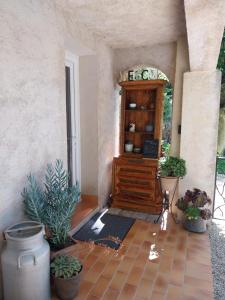 an entrance to a house with plants and a cabinet at Gite du Prinas in Gréolières +19 photos
