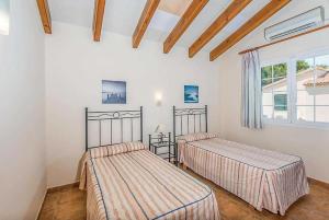 Łóżko lub łóżka w pokoju w obiekcie Villa Judith En Menorca