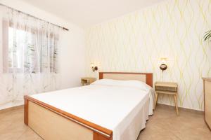 Postel nebo postele na pokoji v ubytování Apartments Dominik