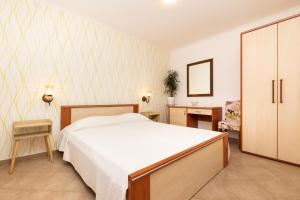 Postel nebo postele na pokoji v ubytování Apartments Dominik