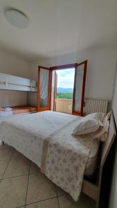 a bedroom with a large bed with a window at Il Chicco apartment in Lamporecchio