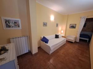 a bedroom with a bed and a chair in a room at Butterfly in Bagnoregio