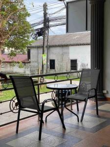 a table and two chairs sitting on a balcony at Chernin hotel & Spa in Ban Bang Chak