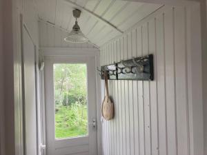 a hallway with a window and a spoon on the wall at Pipowagen Warm Welkom in Wezep