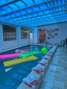 a swimming pool with several inflatable tubes in it at Villa Magnolia in Manot in Manot