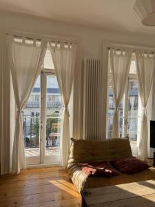 a living room with a couch and large windows at Luminous Town house by the sea in Kent