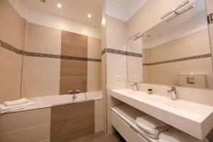 a bathroom with two sinks and a mirror at Paris Square in Paris