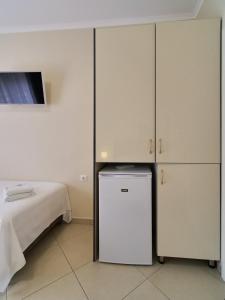a room with a bed and two white cabinets at Himara Royal Hotel in Himare