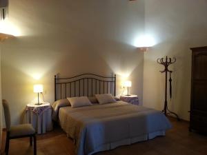 a bedroom with a large bed with two tables and two lamps at Agroturismo Finca Son Sala in Campos